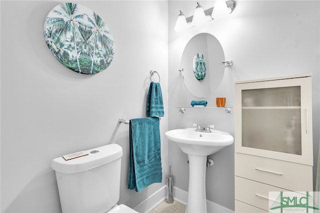 bathroom featuring toilet and tile patterned floors