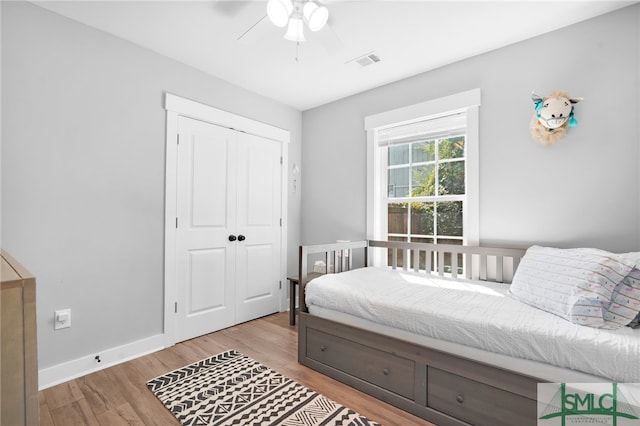 bedroom featuring ceiling fan, a closet, and light hardwood / wood-style floors