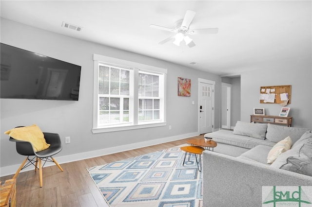 living room with ceiling fan and light hardwood / wood-style floors