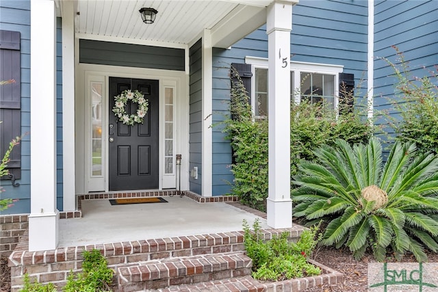 entrance to property featuring a porch