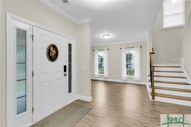 entryway featuring crown molding and hardwood / wood-style floors