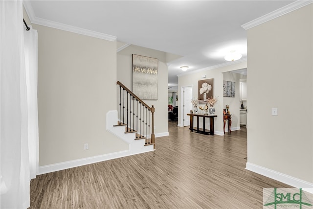 entryway featuring wood-type flooring and crown molding