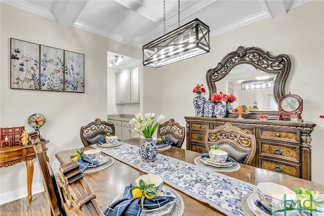 dining space featuring an inviting chandelier, beamed ceiling, crown molding, and hardwood / wood-style flooring