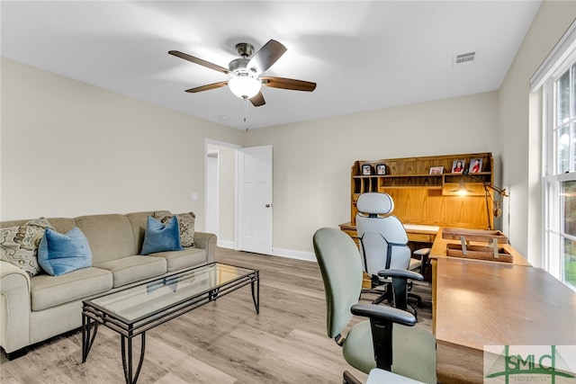 home office with light hardwood / wood-style flooring, a wealth of natural light, and ceiling fan