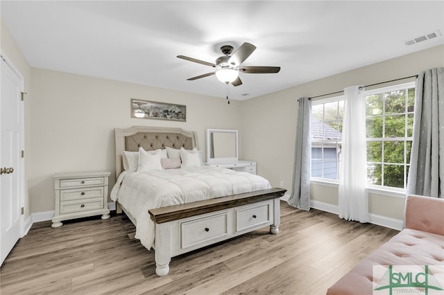 bedroom with light hardwood / wood-style floors and ceiling fan