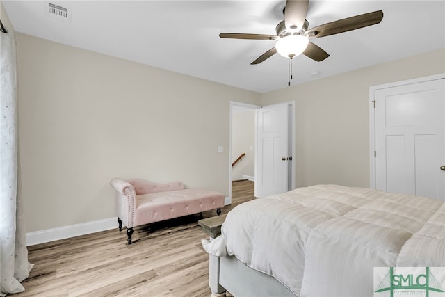 bedroom with ceiling fan and light hardwood / wood-style flooring