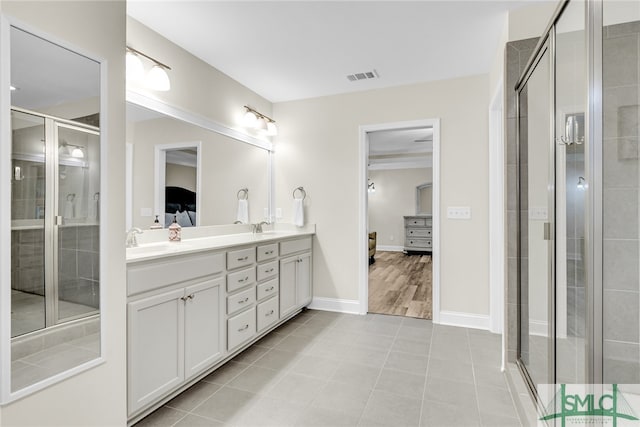 bathroom with tile patterned floors, walk in shower, and vanity