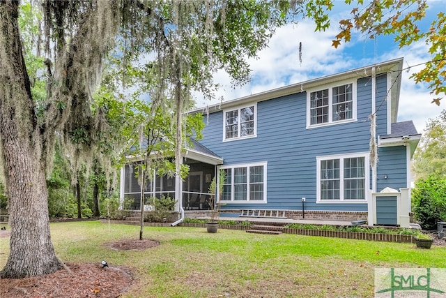 back of property featuring a lawn and a sunroom