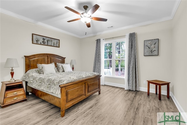 bedroom featuring ceiling fan, light hardwood / wood-style flooring, and ornamental molding