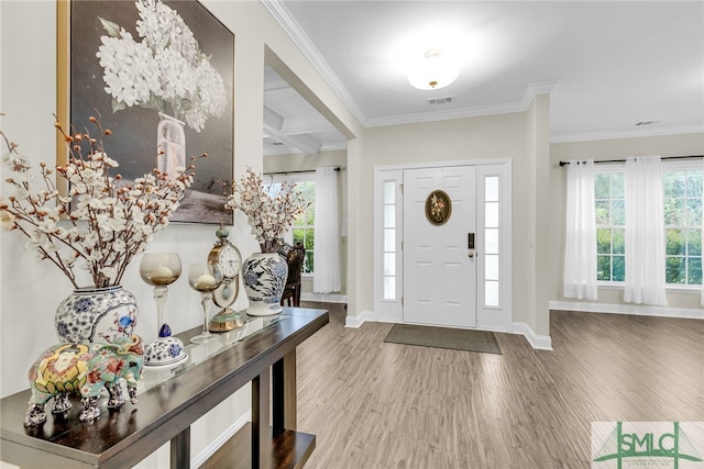 foyer entrance featuring crown molding, beam ceiling, and hardwood / wood-style flooring