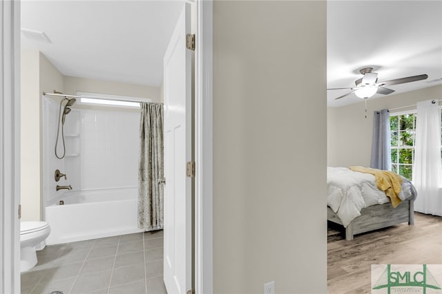 bathroom with shower / bath combo, ceiling fan, hardwood / wood-style flooring, and toilet