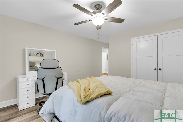 bedroom featuring ceiling fan, light hardwood / wood-style flooring, and a closet