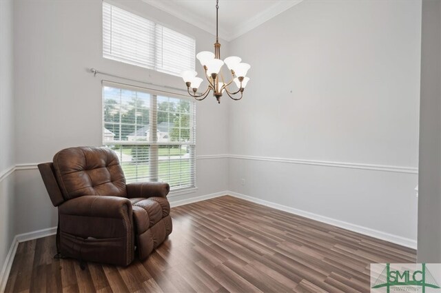 living area featuring ornamental molding, dark hardwood / wood-style floors, and a notable chandelier