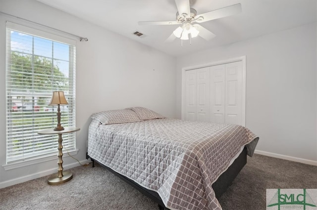 carpeted bedroom with ceiling fan and a closet