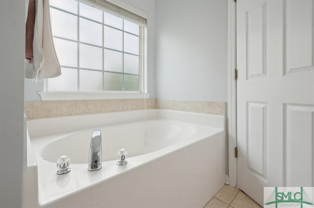 bathroom with tile patterned flooring, plenty of natural light, and tiled tub