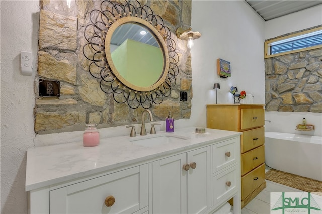 bathroom with vanity, a bathtub, and tile patterned floors