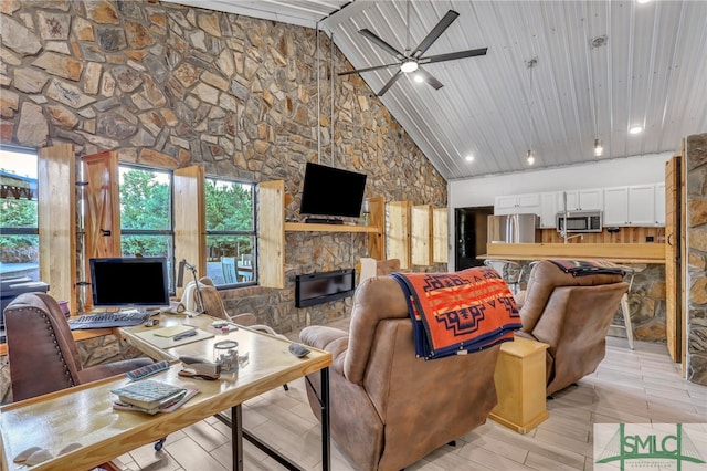 living room with high vaulted ceiling, light hardwood / wood-style flooring, ceiling fan, a stone fireplace, and wood ceiling