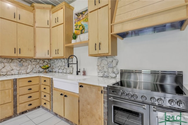 kitchen with range with two ovens, custom range hood, sink, light brown cabinets, and decorative backsplash