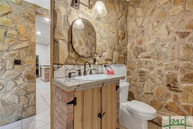 bathroom with backsplash, vanity, toilet, and tile patterned floors