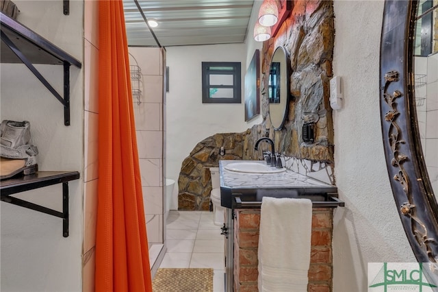 bathroom with tile patterned flooring, vanity, toilet, and curtained shower