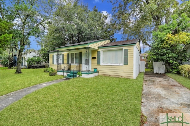 bungalow-style house with a front yard and a porch