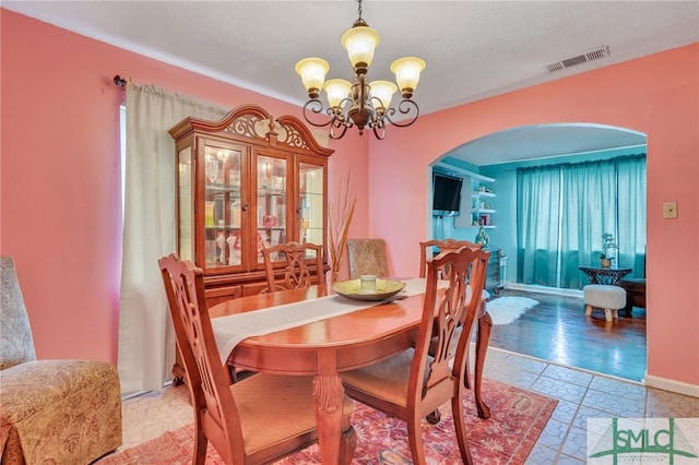 dining room with an inviting chandelier and light hardwood / wood-style floors