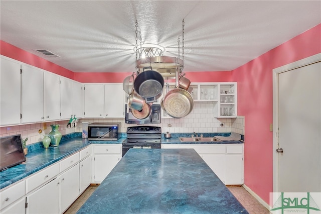 kitchen featuring black appliances, backsplash, sink, and white cabinets