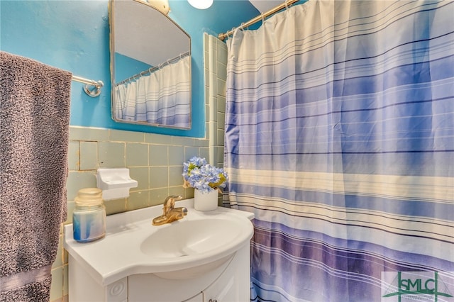 bathroom featuring vanity, tile walls, and backsplash