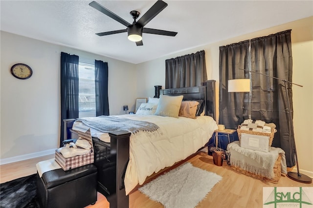 bedroom with light hardwood / wood-style flooring and ceiling fan