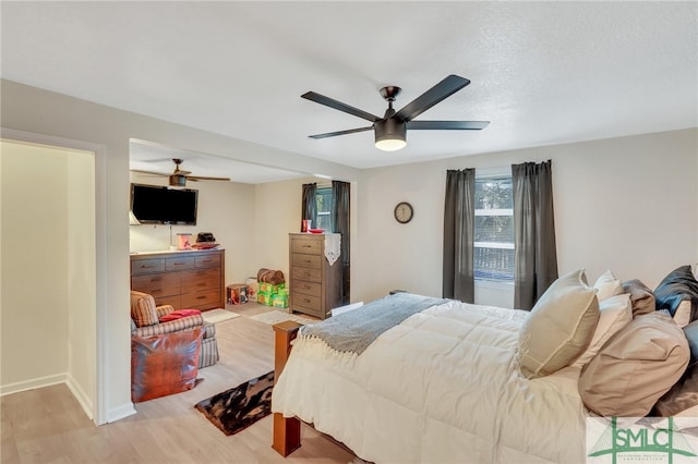 bedroom with light wood-type flooring and ceiling fan