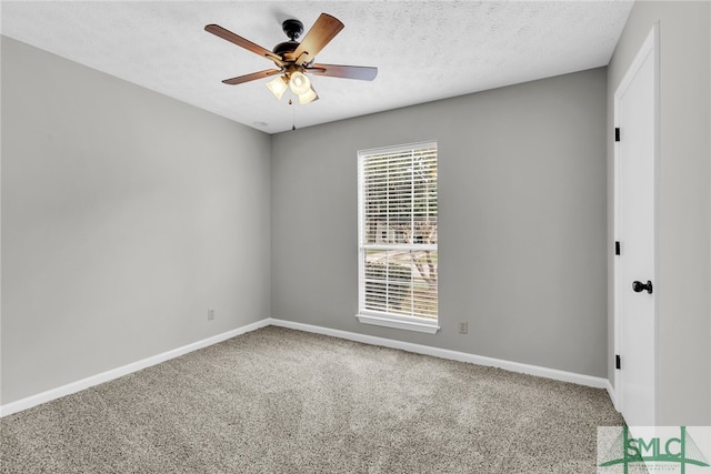 carpeted empty room featuring a textured ceiling and ceiling fan