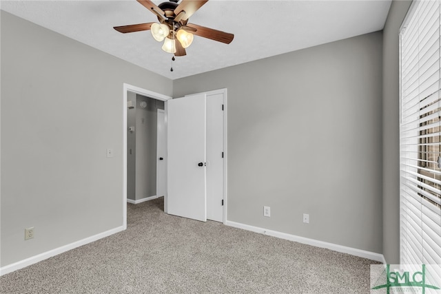 unfurnished bedroom featuring ceiling fan and light carpet