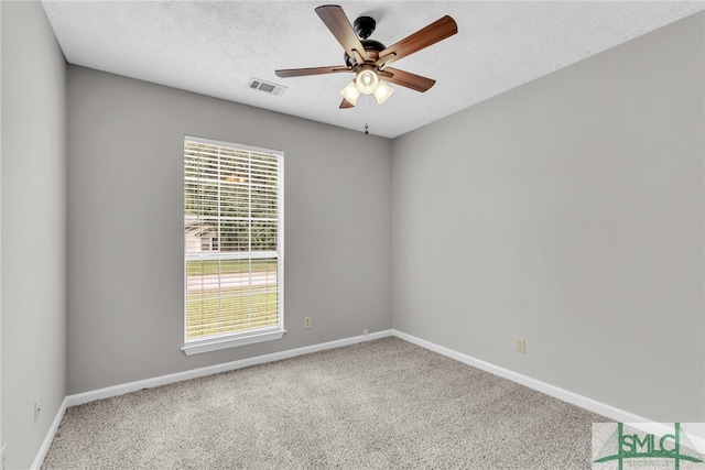 empty room featuring a textured ceiling, carpet flooring, and ceiling fan