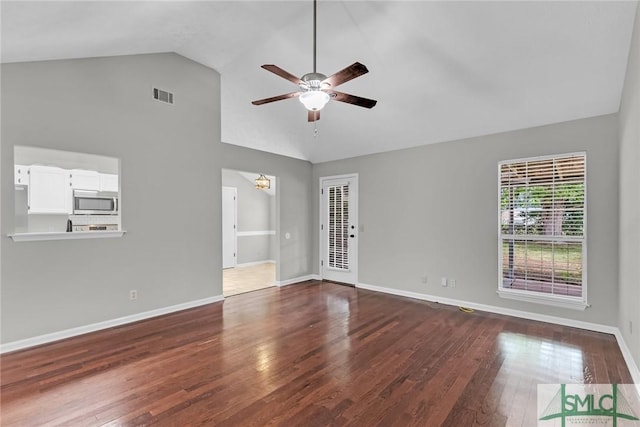 spare room featuring visible vents, high vaulted ceiling, a ceiling fan, wood-type flooring, and baseboards