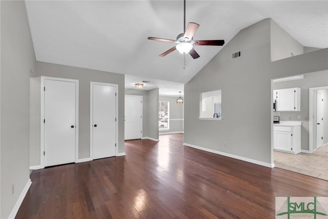 unfurnished living room featuring visible vents, baseboards, ceiling fan, and wood finished floors