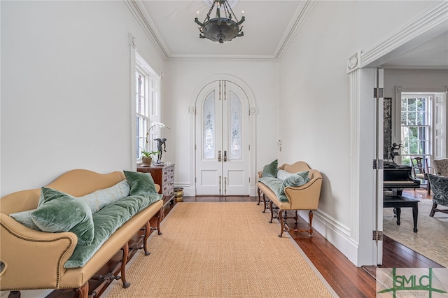 interior space featuring hardwood / wood-style floors, a notable chandelier, and ornamental molding