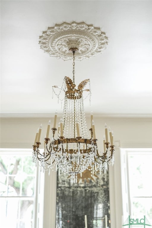 details with crown molding and a notable chandelier