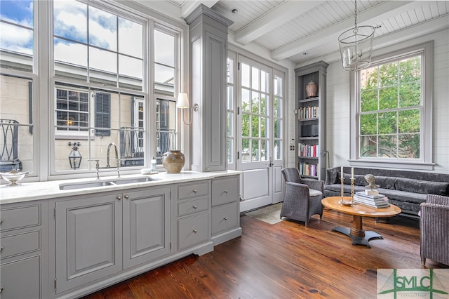 bathroom featuring beamed ceiling, hardwood / wood-style flooring, wooden ceiling, and vanity