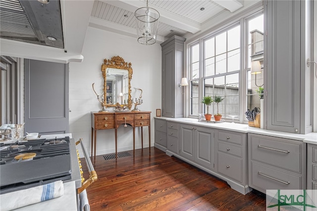 interior space featuring decorative light fixtures, wood ceiling, dark hardwood / wood-style flooring, gray cabinets, and beam ceiling