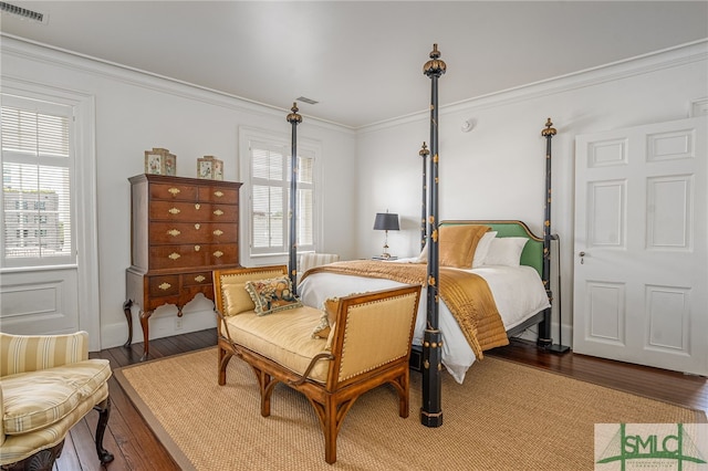 bedroom with crown molding and hardwood / wood-style flooring