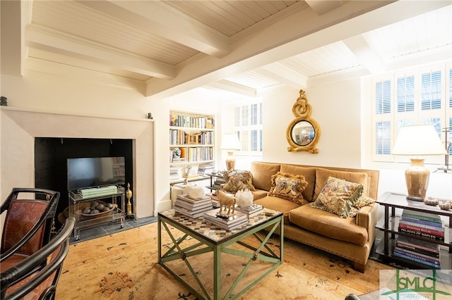 living room with a healthy amount of sunlight, wooden ceiling, and beam ceiling