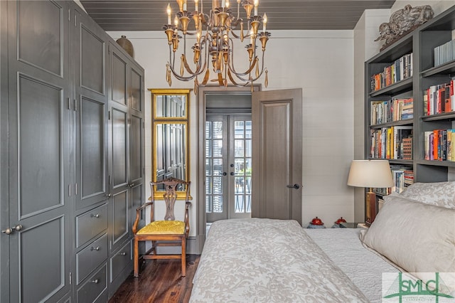 bedroom with dark wood-type flooring, a notable chandelier, and wooden ceiling