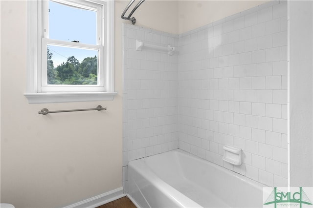 bathroom featuring tiled shower / bath and plenty of natural light