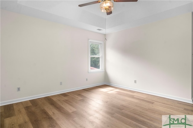 empty room with ceiling fan and wood-type flooring