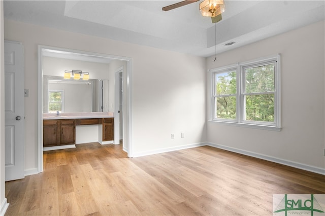 unfurnished bedroom with light wood-type flooring, ceiling fan, and a textured ceiling