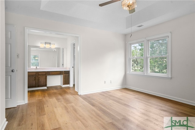 unfurnished bedroom featuring a textured ceiling, light hardwood / wood-style flooring, and ceiling fan