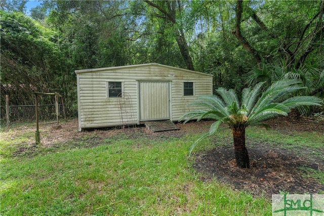 view of outbuilding with a lawn