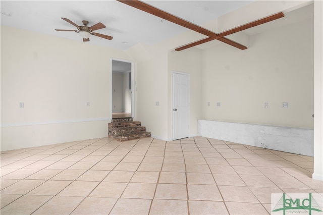 unfurnished living room featuring beamed ceiling, light tile patterned floors, and ceiling fan