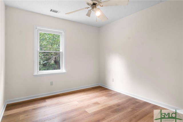 empty room with a textured ceiling, ceiling fan, and light hardwood / wood-style floors