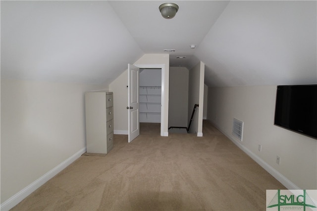 bonus room featuring light carpet and vaulted ceiling